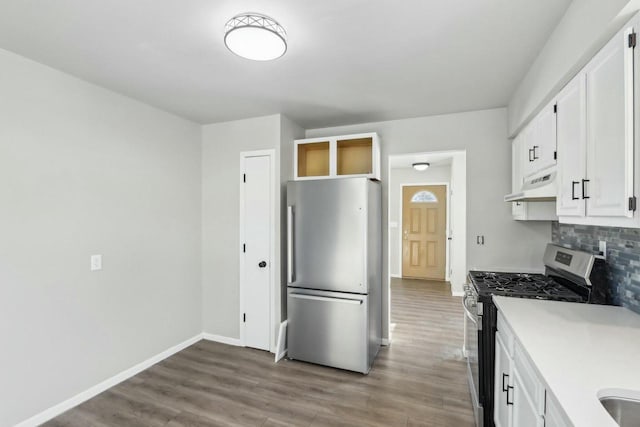 kitchen featuring backsplash, appliances with stainless steel finishes, light wood-type flooring, and white cabinets