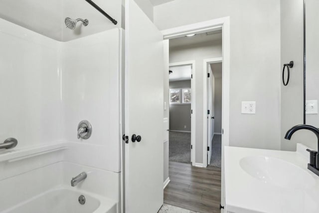 bathroom featuring vanity, wood-type flooring, and  shower combination