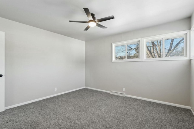 spare room with ceiling fan and dark carpet