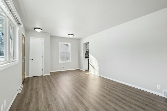 unfurnished room with dark wood-type flooring