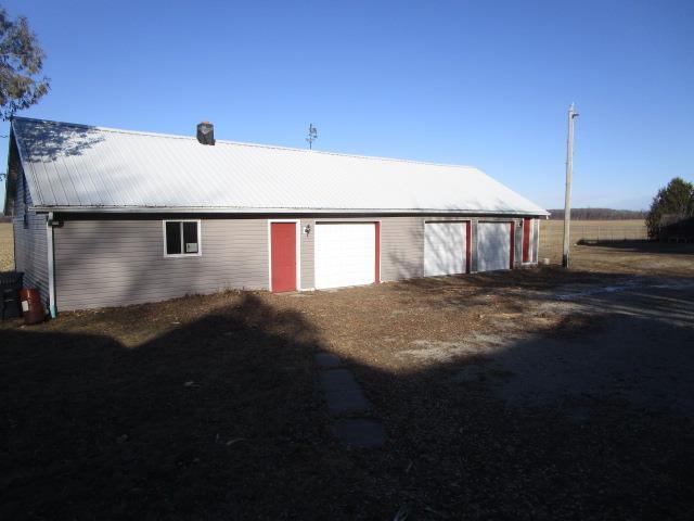 exterior space featuring a garage and an outdoor structure