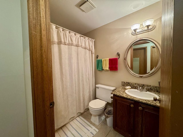 bathroom with tile patterned flooring, vanity, and toilet