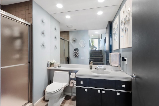 bathroom with vanity, toilet, and an enclosed shower