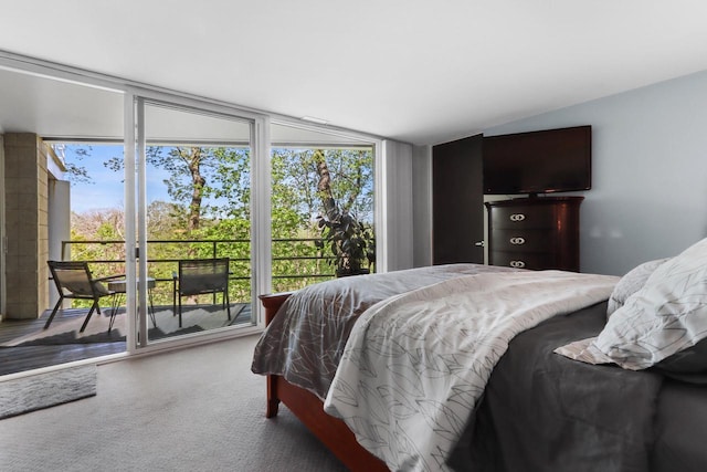 carpeted bedroom featuring lofted ceiling and access to exterior