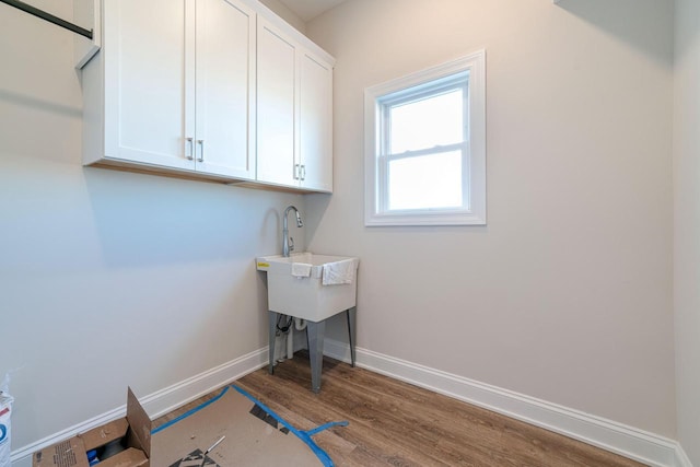 laundry area with dark wood-type flooring