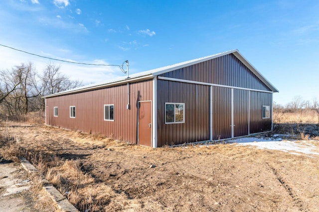 view of side of property featuring an outbuilding