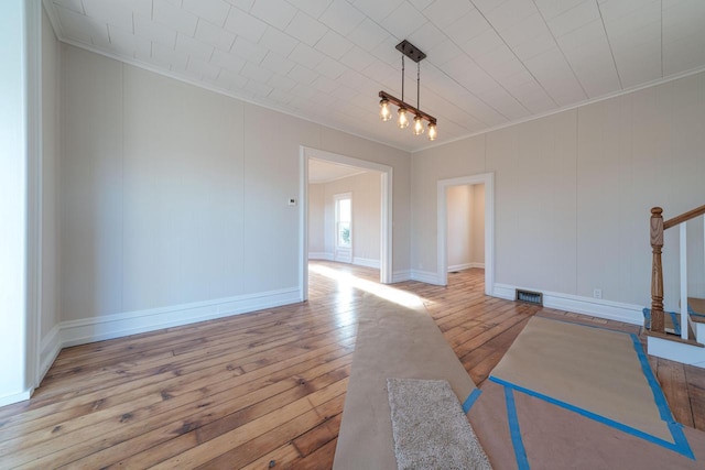 interior space featuring light hardwood / wood-style flooring and ornamental molding