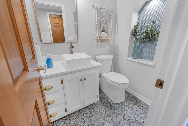 bathroom featuring vanity, tile patterned floors, and toilet