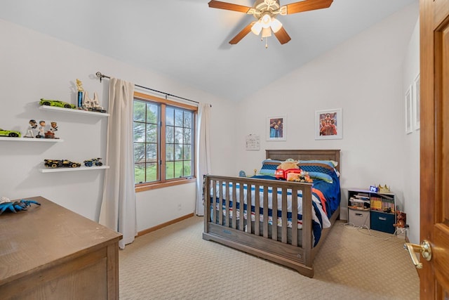 carpeted bedroom with vaulted ceiling and ceiling fan