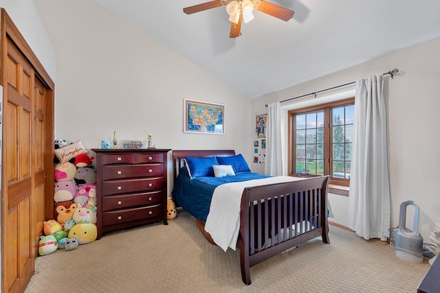 carpeted bedroom with lofted ceiling, ceiling fan, and a closet