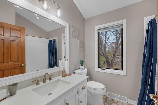 bathroom with vanity, toilet, curtained shower, and vaulted ceiling