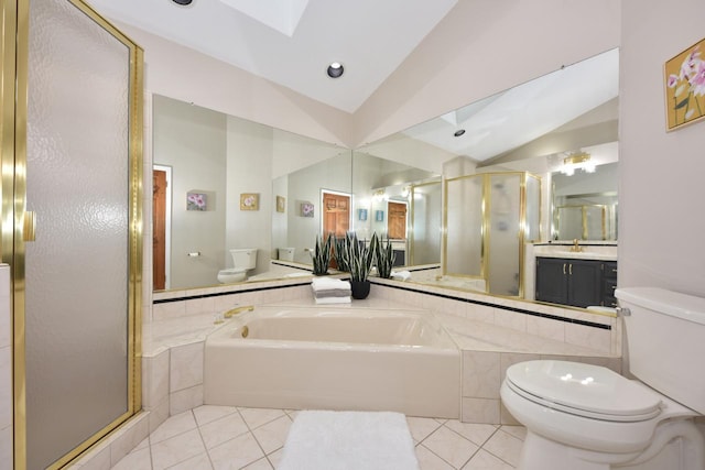 full bathroom featuring toilet, shower with separate bathtub, vanity, vaulted ceiling with skylight, and tile patterned flooring