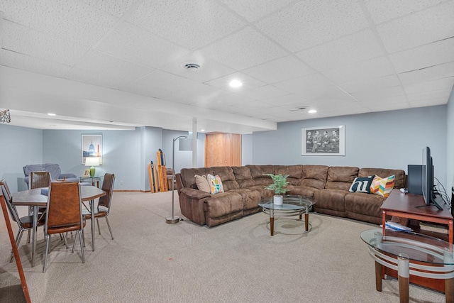 carpeted living room featuring a paneled ceiling