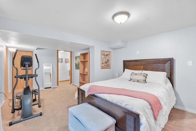 bedroom with light colored carpet and a textured ceiling