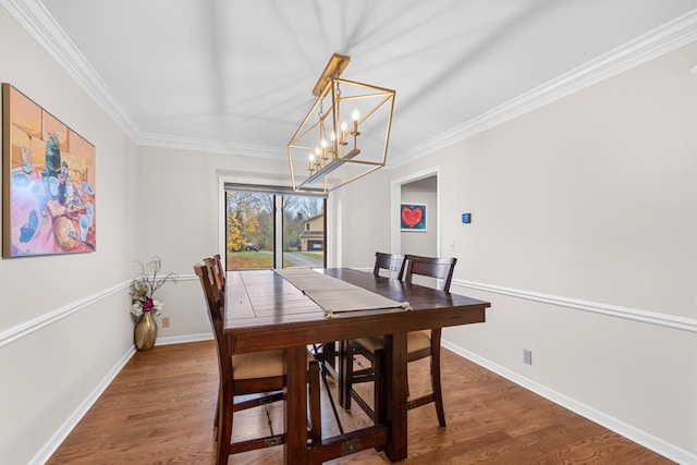 dining room with ornamental molding, dark wood-type flooring, and a notable chandelier