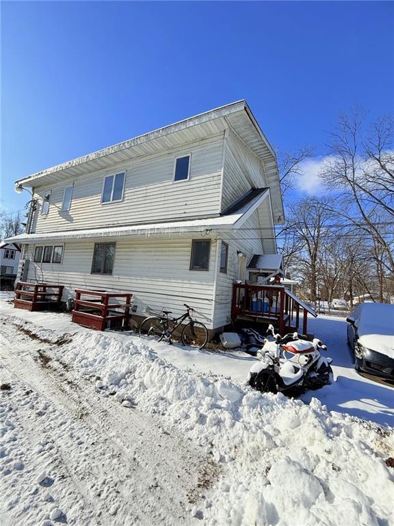 view of snow covered rear of property