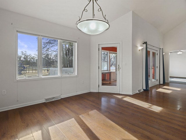 unfurnished room featuring dark hardwood / wood-style floors and vaulted ceiling