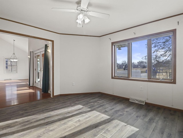 empty room with hardwood / wood-style flooring, ceiling fan, ornamental molding, and lofted ceiling