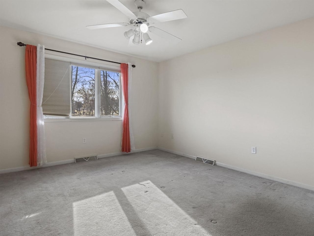 empty room with light colored carpet and ceiling fan