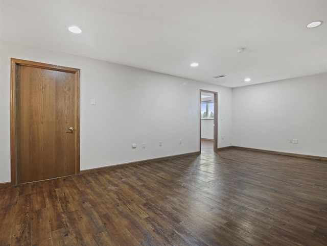 spare room with dark wood-type flooring