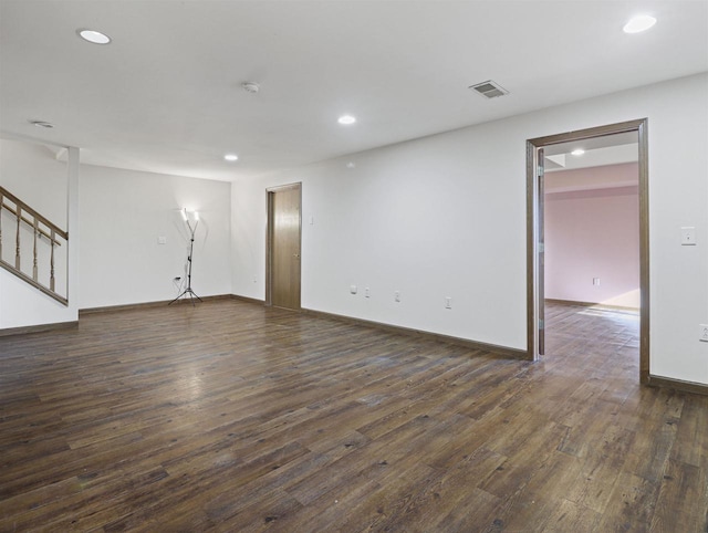 unfurnished living room with dark wood-type flooring