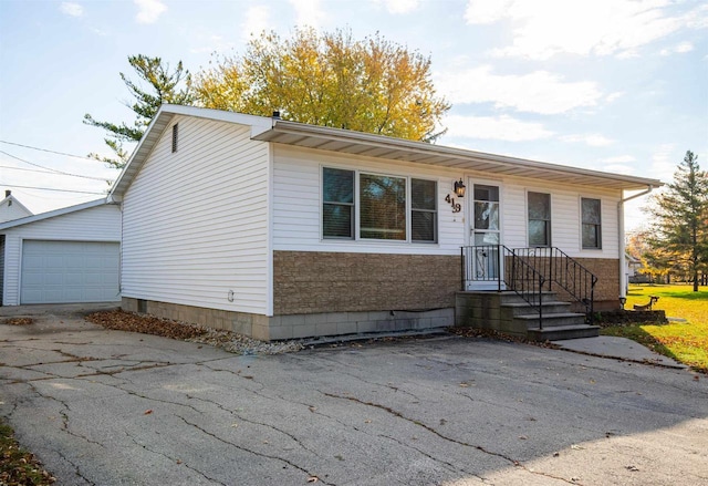 view of front of home with a garage and an outdoor structure