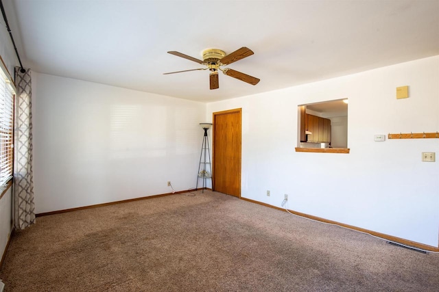 carpeted spare room featuring ceiling fan