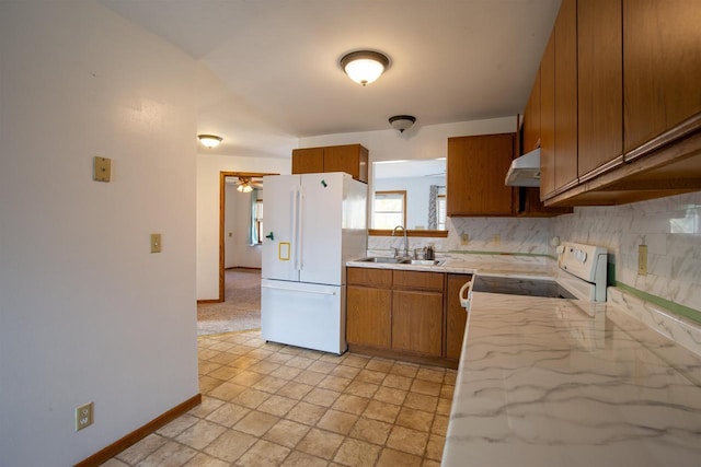 kitchen featuring white appliances, sink, and decorative backsplash