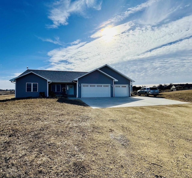 ranch-style home featuring a garage and a front lawn