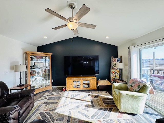 living room with hardwood / wood-style flooring, vaulted ceiling, and ceiling fan