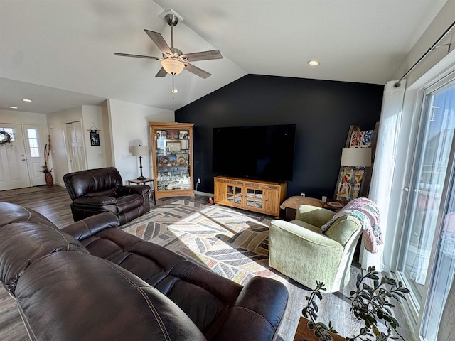 living room with wood-type flooring, lofted ceiling, and ceiling fan