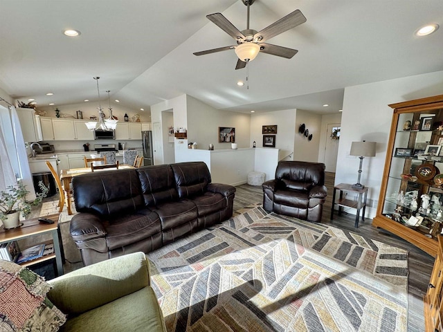 living room featuring ceiling fan, sink, vaulted ceiling, and hardwood / wood-style floors