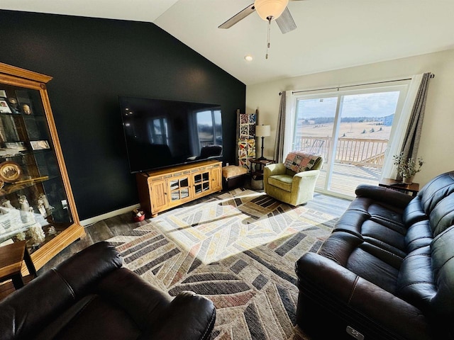 living room featuring hardwood / wood-style floors, vaulted ceiling, and ceiling fan