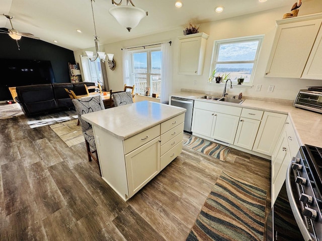 kitchen featuring sink, range, decorative light fixtures, a center island, and stainless steel dishwasher