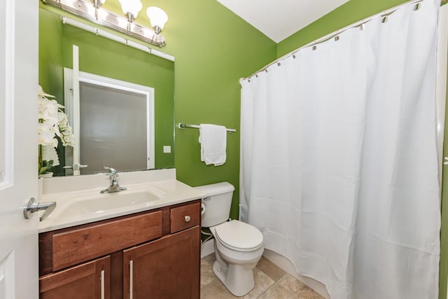 bathroom featuring vanity, tile patterned floors, and toilet