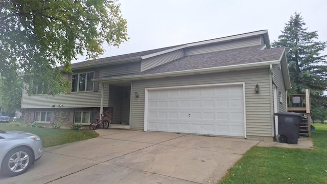 view of front of home featuring a garage and a front lawn