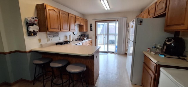 kitchen with kitchen peninsula and a breakfast bar area