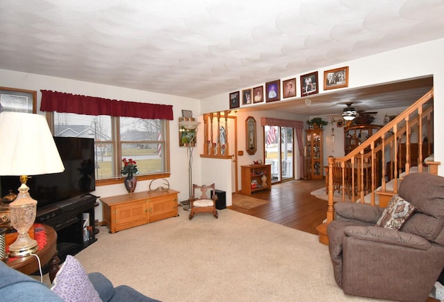 living room featuring carpet and ceiling fan