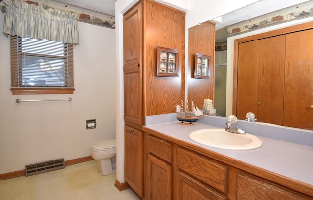 bathroom with vanity and toilet