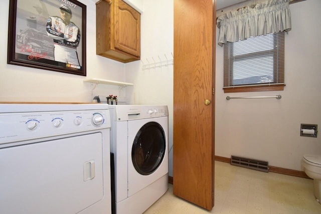 laundry area featuring cabinets and washer and dryer