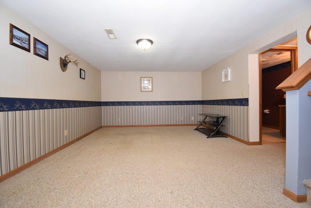 basement featuring light colored carpet