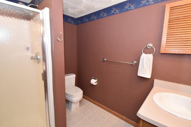 bathroom with vanity, tile patterned flooring, a shower with shower door, and toilet