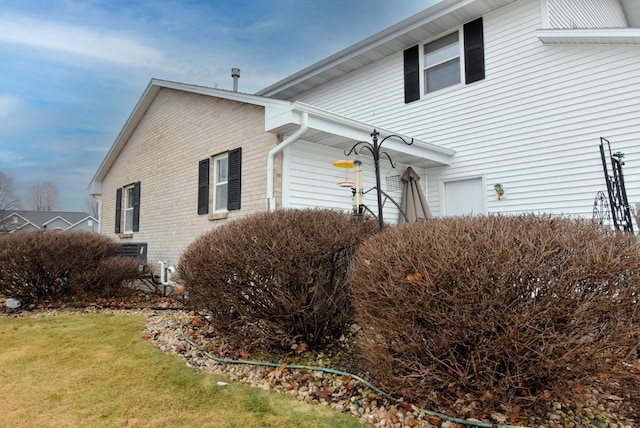 view of side of property with a lawn