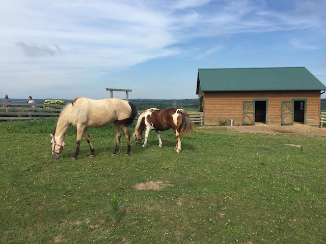 view of horse barn with a rural view