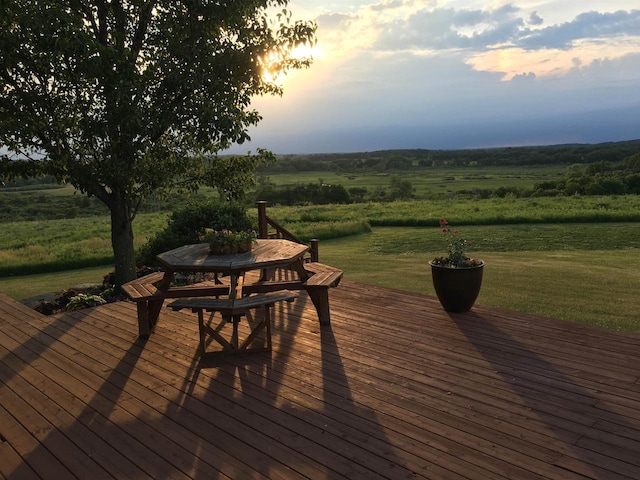 deck with a rural view and a lawn