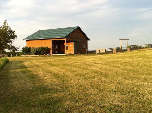 view of outbuilding featuring fence