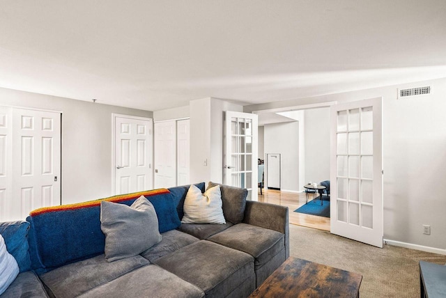 carpeted living room with french doors