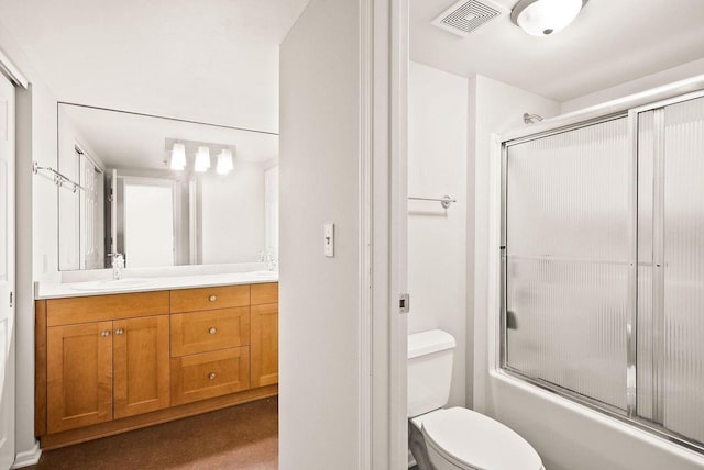 full bathroom with vanity, shower / bath combination with glass door, and toilet