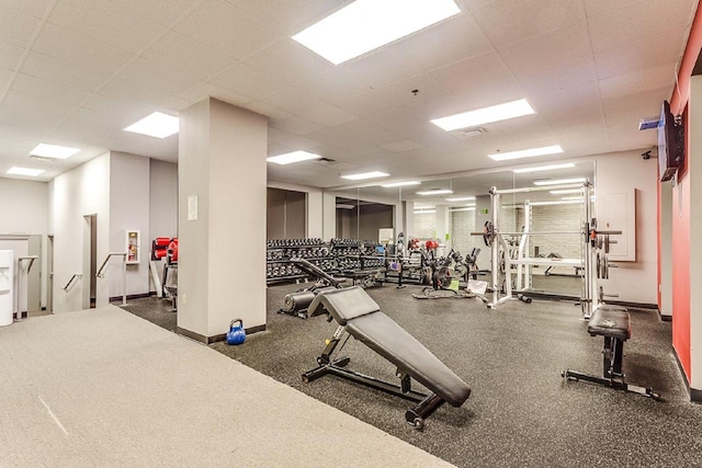 exercise room with a paneled ceiling