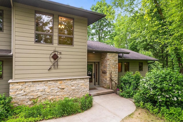 E4725 Riverside Dr, Spring Green, WI 53588 - view of exterior entry with stone siding and roof with shingles